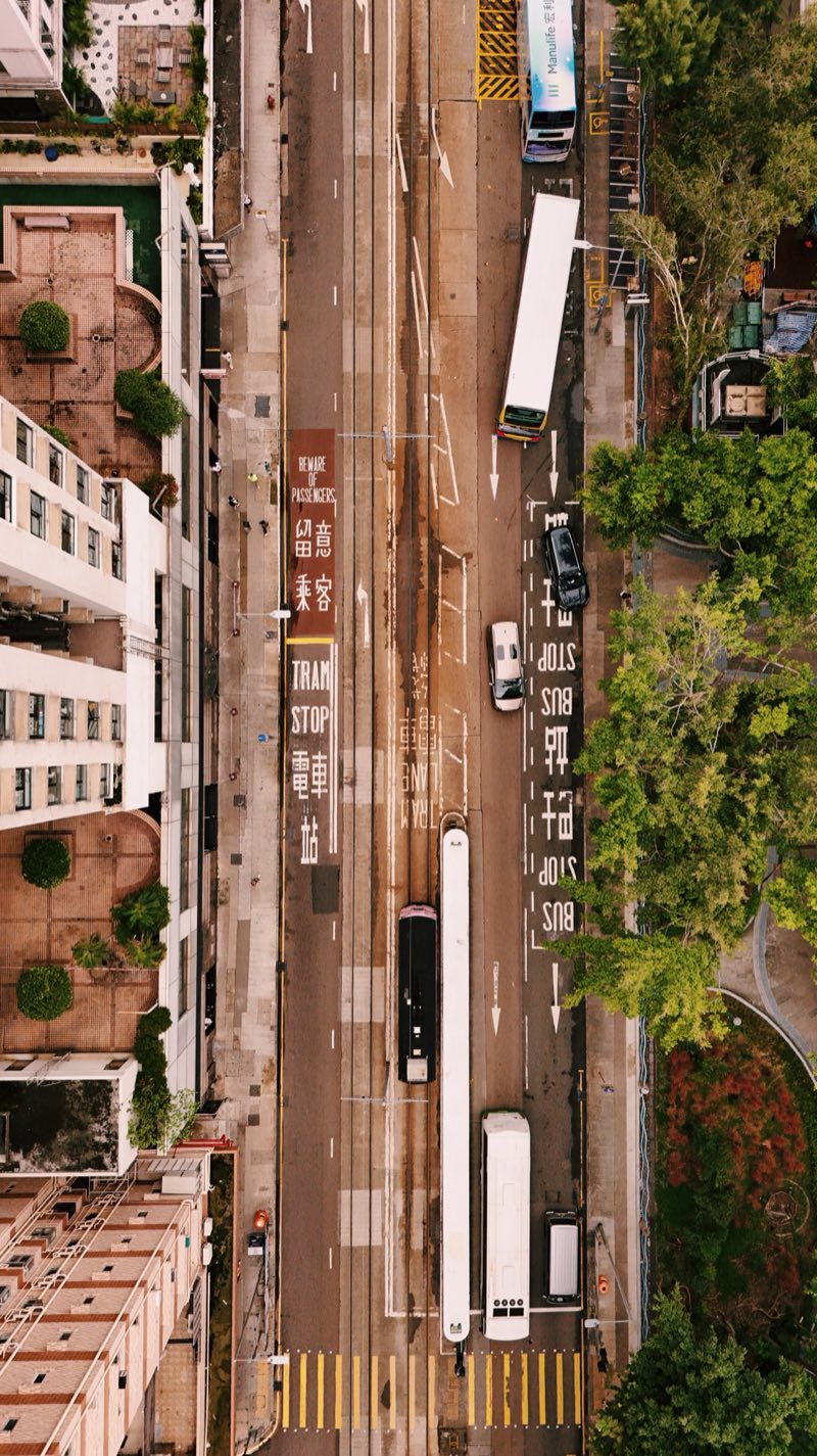 Looking straight down on a city street with double-decker buses.